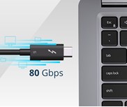 A close-up of a black Thunderbolt™ 5 cable connected to a laptop. The text